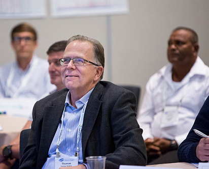 man in blue shirt smiling at a respect for people event